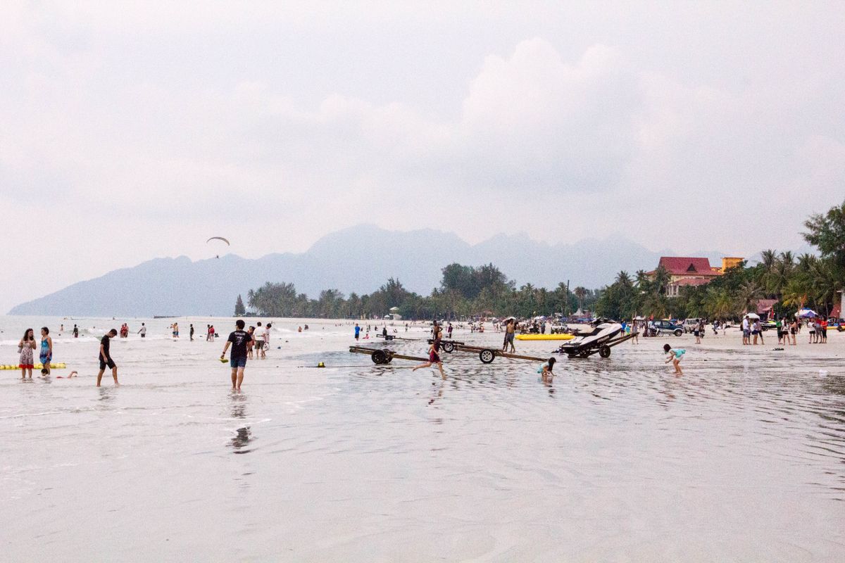 People relaxing on a sandy Langkawi beach in the afternoon