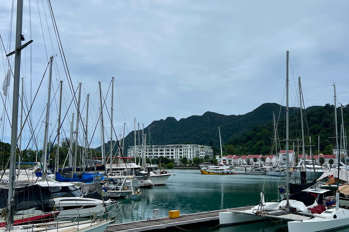Yachts moored at a Langkawi marina under a cloudy sky