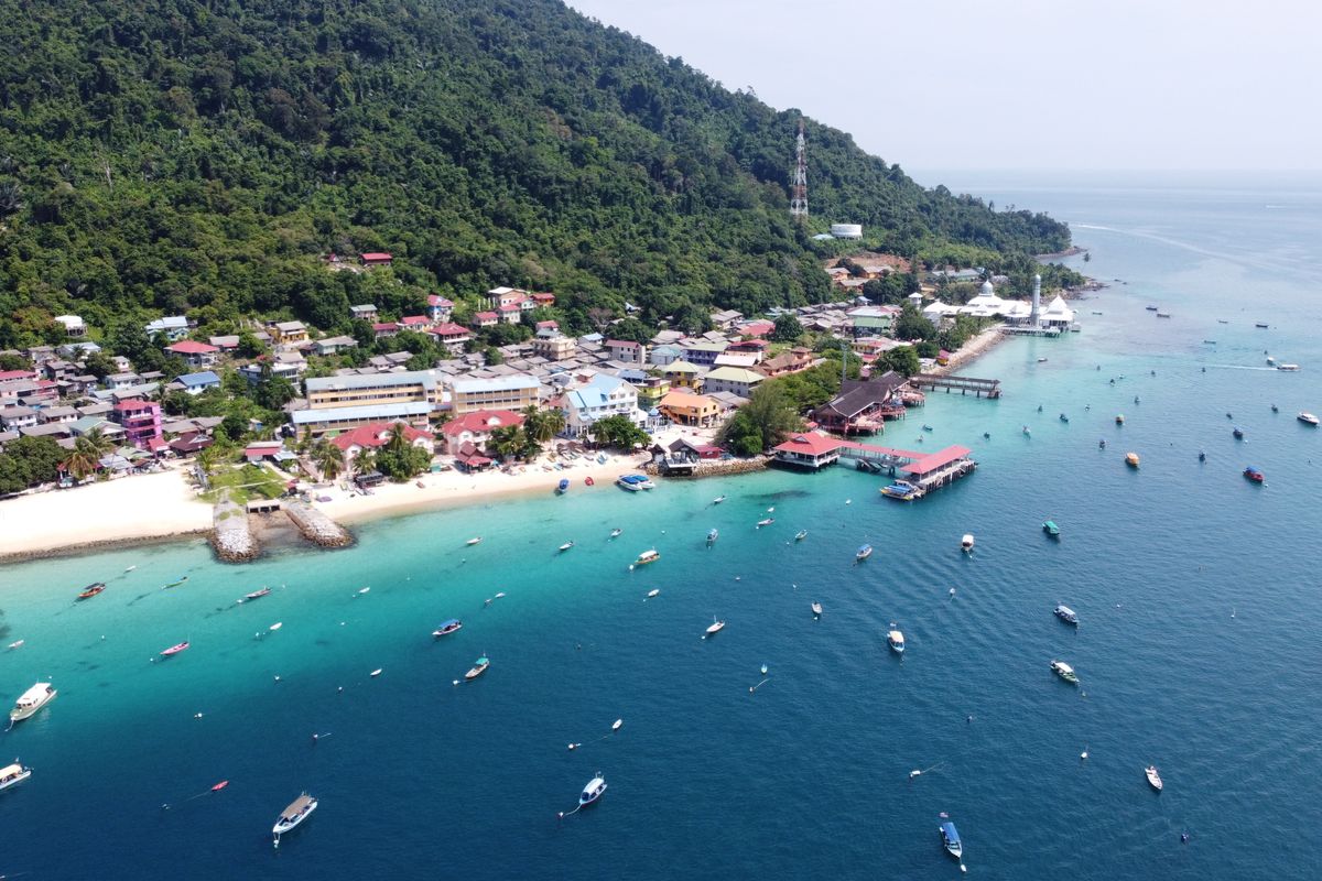 Aerial view of a Malaysian island fishing village and turquoise coast
